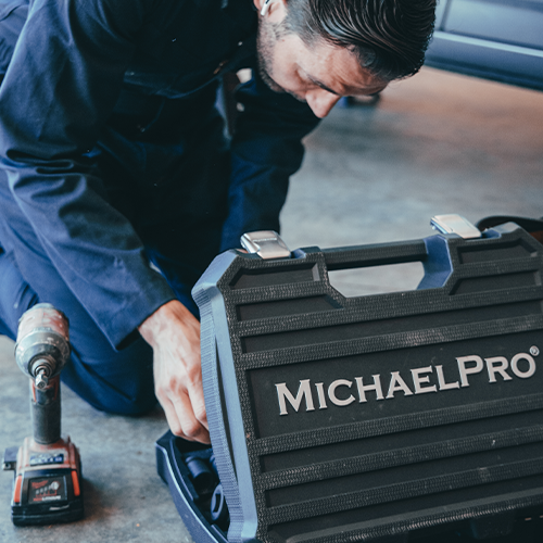mechanic using tools to perform maintenance tasks